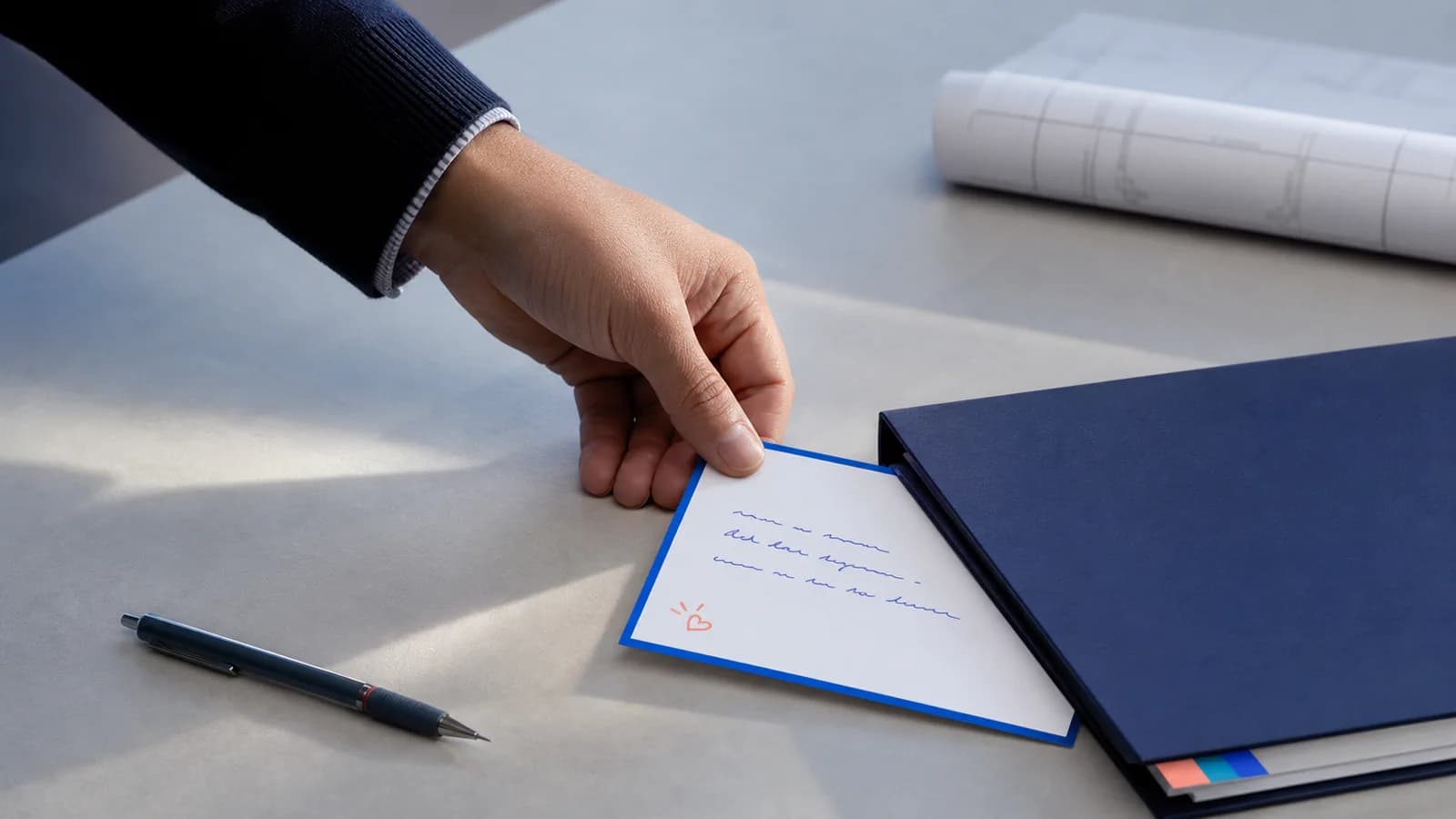 Team member leaving a handwritten thank-you card on a manager's desk